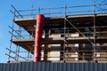 Scaffolding surrounding house development for safe access to construction work Royalty Free Stock Photo