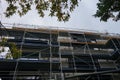 Scaffolding surrounds a residential apartment building under construction. Berlin, Germany