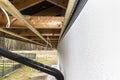 Scaffolding with three rows of wooden battens for attaching the PVC soffit, visible cables for lighting.