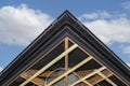 Scaffolding with three rows of wooden battens for attaching the PVC soffit, visible cables for lighting.