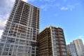 Scaffolding used in construction new building. Facade of a new modern high-rise residential building. Skyscraper on blue sky Royalty Free Stock Photo