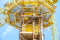 Scaffolding work on offshore oil and gas central processing platform while erected to crane column for repair structure of crane. Royalty Free Stock Photo