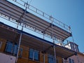 Scaffolds on a house building under renovations Royalty Free Stock Photo