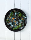 Scald mussel with thai sweet basil in black plate