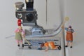 Scale H0 diorama :three housewives clean a sewing foot of an electric sewing machine