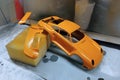 Scale model hobby. Paint the spoiler, trunk lid and toy body in a bright orange color