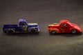 Scale models of metal toy carts on a black background.