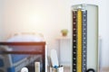 Scale of sphygmomanometer with other medical object on table in room Royalty Free Stock Photo