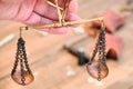 Scales of bronze on a chain in a woman`s hand. Vintage scales for weighing precious metals and money Royalty Free Stock Photo