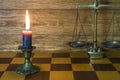 A scales from a bronze, a con flagrant candle stands on a chess-boards