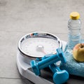 Scales after exercise, slimming aerobics and weight control, copy space Royalty Free Stock Photo