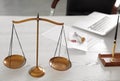 Scales of justice on desk Royalty Free Stock Photo