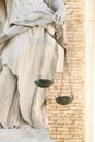 Scales of justice in hand at the marble statue Royalty Free Stock Photo