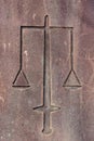 Scales of Justice Motif Carved on Sandstone Wall