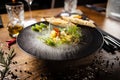Scallop ceviche with mango, chilli and cilantro served with liquid ice smoke in a plate. Delicious healthy food closeup Royalty Free Stock Photo