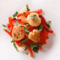 Scallops grilled with peppers on a plate close-up. horizontal to Royalty Free Stock Photo