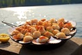 scallops in a seashell serving dish beside beach bbq