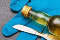 Scalpel, a bottle of whiskey and gloves on the table. Concept of alcohol abuse by doctors