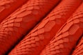red snake skin texture, reptile leather as background Royalty Free Stock Photo