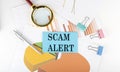 SCAM ALERT text on the sticker on the paper diagram Royalty Free Stock Photo