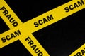 Scam and fraud alert, caution and warning concept. Yellow barricade tape with word scam Royalty Free Stock Photo