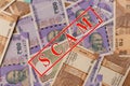 Scam and money concept, Scam in red alphabets printed on Indian currency Notes Royalty Free Stock Photo