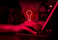 Digital key on red virtual screen with virus, bugs, bomb and privacy information symbol while hacker stealing data on laptop. Royalty Free Stock Photo