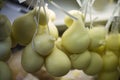 Scamorza cheese hunged exposed in the shop