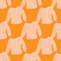 Scandi fashion seamless pattern with light knitted sweater shapes on bright orange background