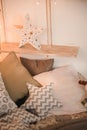 Scandinavian bedroom interior for the New Year. Background for a Christmas card in light colors of a bedroom Rustic bed with pillo