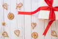 Scandinavian christmas concept with gift box and assorted scandinavian straw decorations lay flat on a wooden background