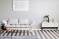 Scandinavian futon in beige living room interior with black and white floor Royalty Free Stock Photo