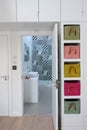 Light-filled bedroom interior looking into ensuite bathroom with monochrome tiles.