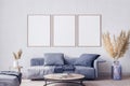 Poster frame mock up in living room interior with blue sofa and pa,pas grass