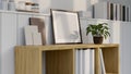 Scandinavian minimal living room interior close-up, An empty frame mockup on a wooden bookcase Royalty Free Stock Photo