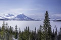 Scandinavian mountain range covered by ice and snow, frozen lake, blue skies, pine forest Royalty Free Stock Photo