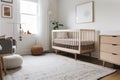 scandinavian nursery with minimalist crib, dresser and nightstand Royalty Free Stock Photo