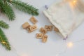 Scandinavian runes and a light sack lie on a white table with garland lights. The concept of Christmas fortune telling Royalty Free Stock Photo