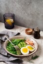 Scandinavian salad with smoked pink salmon, spinach, cucumber and chicken egg in gray ceramic dish Royalty Free Stock Photo