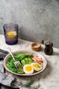 Scandinavian salad with smoked pink salmon, spinach, cucumber and chicken egg in gray ceramic dish. Royalty Free Stock Photo