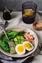 Scandinavian salad with smoked pink salmon, spinach, cucumber and chicken egg in gray ceramic dish. Top view Royalty Free Stock Photo