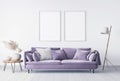 Scandinavian simple interior design mock up. Purple cozy sofa with wooden floor lamp and table. Dried flowers. 2 empty frmaes