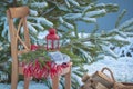 Scandinavian style wool mittens on Christmas plaid and chair near basketful of firewood