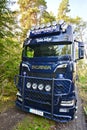 Scania Logging truck loading pine trees in the forest