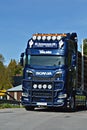 Scania Logging truck loading pine trees in the forest