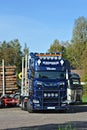 Scania Logging truck loading pine trees in the forest