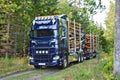 Scania Logging truck loading pine trees in the forest