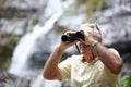 Scanning the landscape for some exotic birds. a senior man looking at scenery with a pair of binoculars. Royalty Free Stock Photo