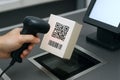 Scanning qr code on box at checkout counter with barcode scanner in retail setting. concept of digital payment, retail technology Royalty Free Stock Photo