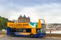 Tourist sight seeing bus at Scarborough sea front.